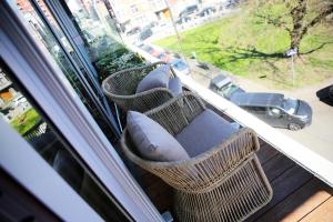 a balcony with pillows and a window with a car at Elite Suite in Liège