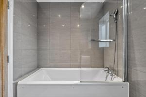 a bath tub in a bathroom with a shower at The Oak Nest in Otford +33 photos