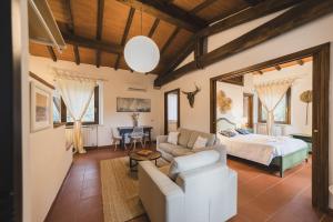 a living room with a bed and a couch at Agriturismo Pimpinnacolo in Porto Ercole