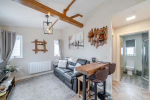 a living room with a couch and a table at 1 Bed Cabin - Sleeps 2 - Pets - 2 Min To Beach in Bridlington