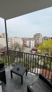 a balcony with a table and a view of a city at Stan na dan Bor in Bor