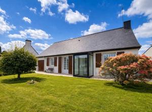 a house with a green lawn in front of it at Ti maeronez in Paimpol