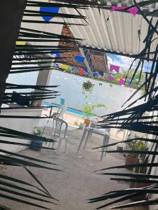 a patio with chairs and a table and a pool at DK eventos in Teresina