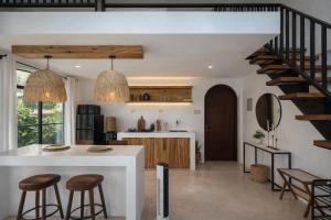 a kitchen with a white counter and a staircase at Villa Adela Siargao in General Luna