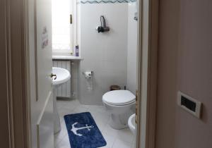 a small bathroom with a toilet and a sink at Tuscan retreat in Orciatico +9 photos