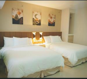 two beds sitting next to each other in a bedroom at Baba Staytion 1-2-3 of SMDC Style Condo in Iloilo City