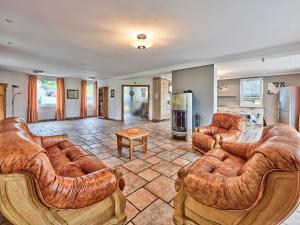 a living room with two couches and a kitchen at Haus Eifelsonne in Ramscheid +2 photos