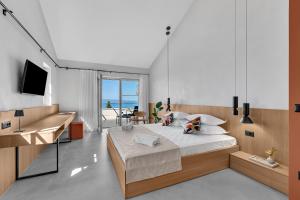 a bedroom with a bed and a desk and a television at Villa Laurante in Tučepi