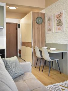 a living room with a couch and a table and chairs at Montewave Studio Apartment in Boreti
