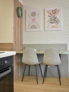 a kitchen with a table and two chairs at Montewave Studio Apartment in Boreti