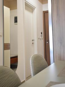 a room with a table and chairs and a mirror at Montewave Studio Apartment in Boreti +9 photos