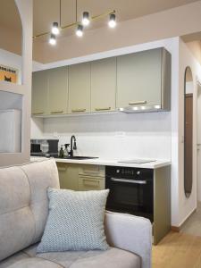 a living room with a couch and a kitchen at Montewave Studio Apartment in Boreti
