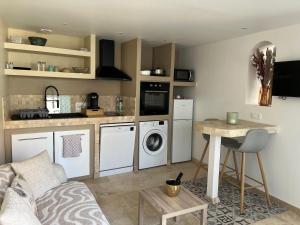 a living room with a kitchen with a washing machine at Douce escale in Le Crotoy