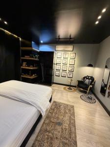 a bedroom with a large white bed and a chair at شقة فندقية بتصميم انيق عصري in Hail