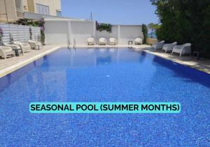 a swimming pool with blue water in a building at Sea Krystel 603 in Larnaca