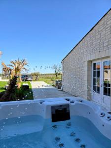 a swimming pool in front of a building at Les Anges de la Vigne par Lisca Begay in Biron