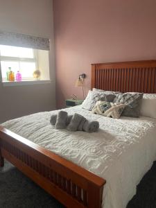 a bedroom with a bed with two towels on it at Warm Spacious apartment in Pembroke Dock