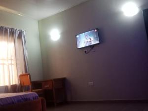 a room with a tv on a wall at Primenest Executive Suites in Gwagwalada
