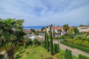 a view of a town with palm trees and a street at Apartment Renata in Njivice