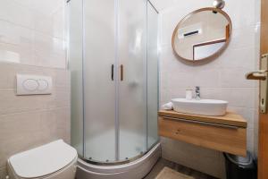 a bathroom with a shower and a sink and a mirror at Apartment Renata in Njivice +57 photos