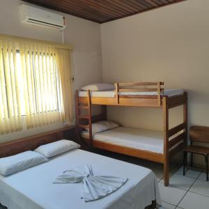 a room with two bunk beds and a window at Hotel Bela Vista in Costa Marques