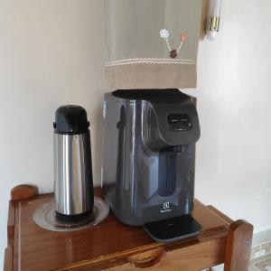 a coffee maker sitting on top of a wooden table at Hotel Bela Vista in Costa Marques