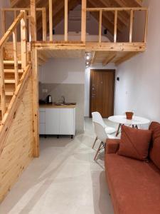 a living room with a couch and a table at Rosea LOFT in Përmet