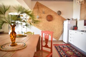 a kitchen with a wooden table with a vase on it at Elefthia Syros - Luxury Houses & Suites in Megas Gialos - Nites