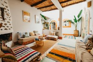 a living room with a couch and a fireplace at Surf HouseMaroc in Essaouira +86 photos