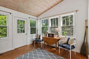 a home office with a desk and chairs and windows at Nan's Escape by Juniper Holiday + Home in Union Pier +23 photos
