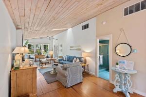 a living room with a wooden ceiling at Nan's Escape by Juniper Holiday + Home in Union Pier