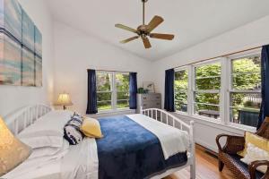 a bedroom with a bed and a ceiling fan at Nan's Escape by Juniper Holiday + Home in Union Pier