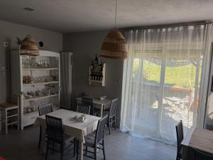 a dining room with a table and chairs and a window at Bed & Breakfast Cascina Beatrice in Rodello