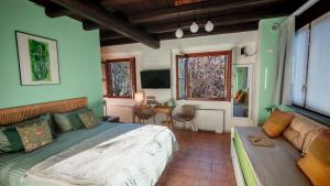 a bedroom with a bed and a couch in it at Cascina Silene in Castelmarte