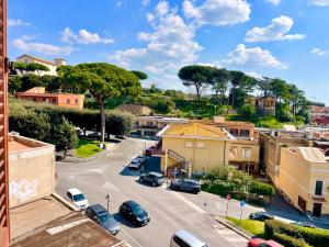 a city street with cars parked in a parking lot at “La Casetta nel Borgo” in Cerveteri