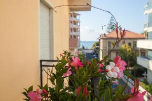 a bunch of flowers sitting on a balcony at Hotel Nello in Marina di Andora