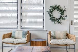 two chairs and a table in a room with windows at Hygge House in Harbert +43 photos