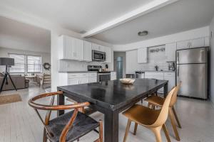 a kitchen with a table and chairs and a refrigerator at Hygge House in Harbert