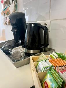a black coffee pot sitting on a counter next to a kitchen at gîte en rdc A 200 m tgv et de la fac A 400 m des places 250 places de parking face au logement in Arras
