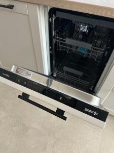 an oven with its door open in a kitchen at Crystal Lakes Apartment in Plitvička Jezera