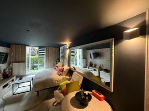 a bedroom with a bed and a large mirror at Le Must - Chambre double entre Paris et Disney in Livry-Gargan