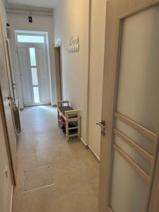 a hallway with a door leading to a room with a table at Crystal Lakes Apartment in Plitvička Jezera +8 photos