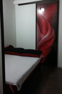 a bed in a room with a red bed frame at Квартира в центрі біля Оперного театру in Lviv