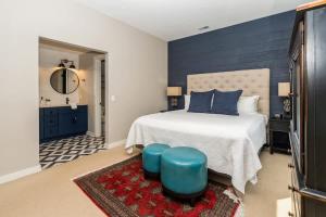 a bedroom with a bed with a blue accent wall at The Vineyard Loft in Harbert