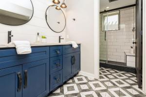 a bathroom with a blue sink and a mirror at The Vineyard Loft in Harbert