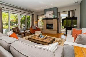 a living room with a couch and a tv at The Vineyard Loft in Harbert