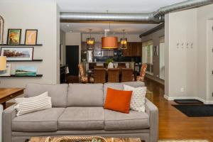 a living room with a couch and a dining room at The Vineyard Loft in Harbert +15 photos