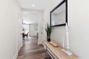 a hallway with a table with a plant on it at Cozy Haven in Three Oaks +29 photos
