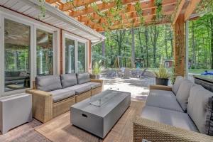 a screened in porch with couches and a coffee table at Wonderwood Cottage in Sawyer