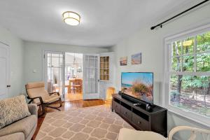 a living room with a flat screen tv and a couch at Wonderwood Cottage in Sawyer +28 photos